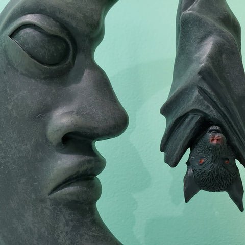 Bat and moon half crescent moon hanging vampire bat